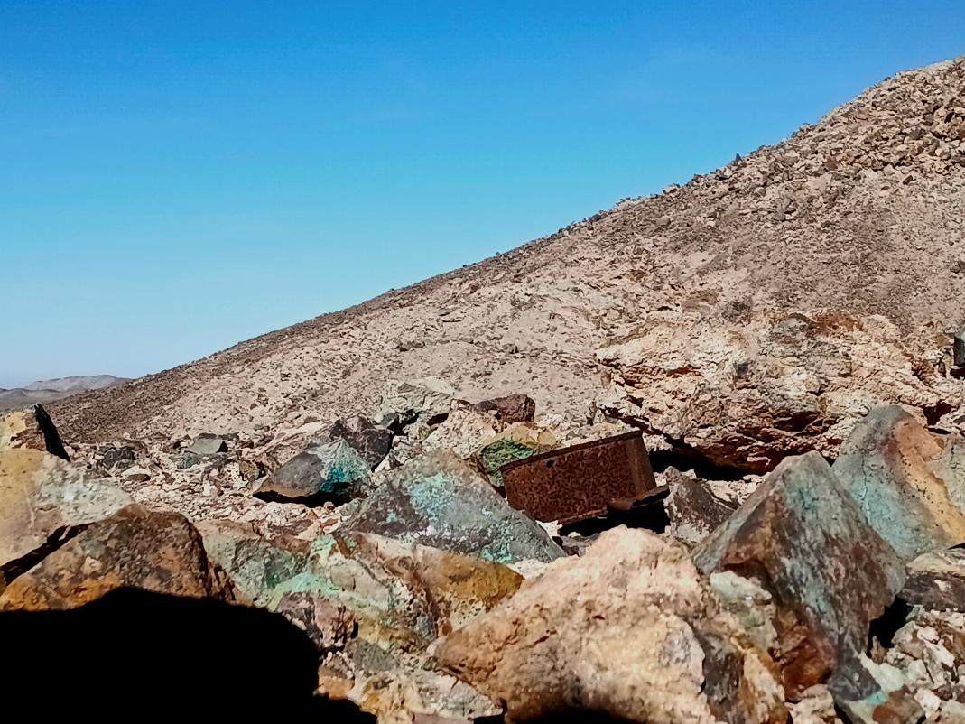 Copper-stained rocks on a hillside at Furano